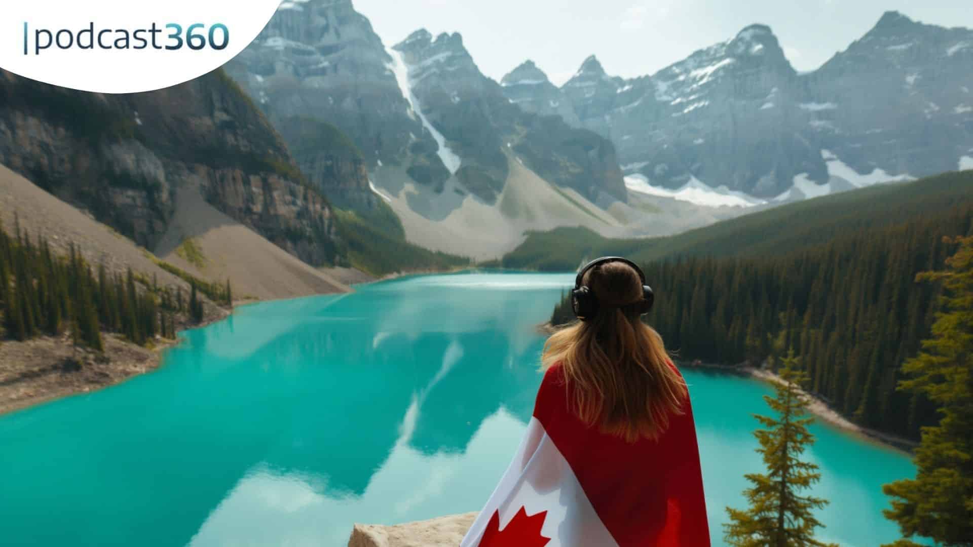 Eine Person mit Kopfhörern und einer kanadischen Flagge blickt auf einen türkisfarbenen See und Berge.